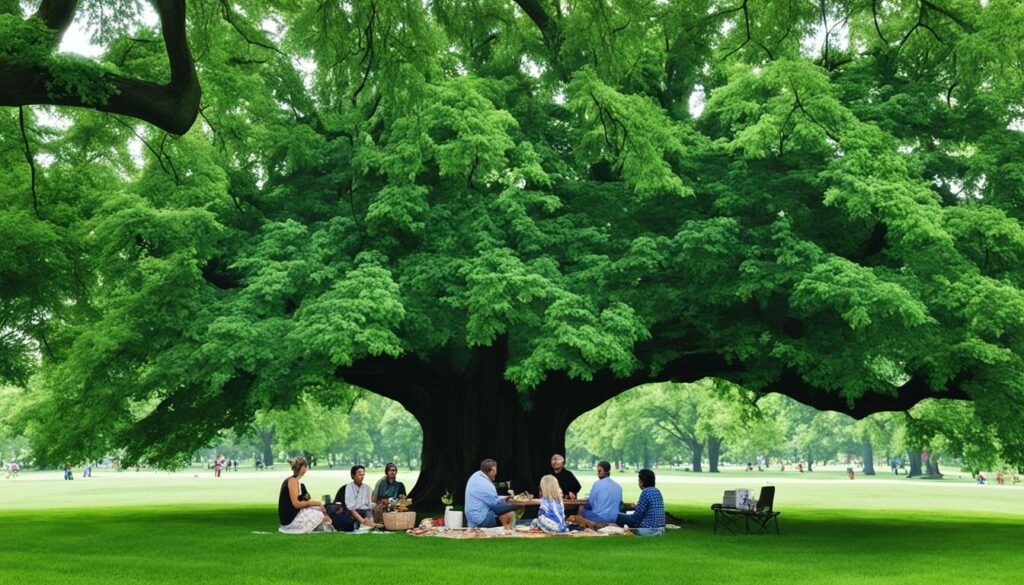 family having a picnic under a large tree in Tower Grove Park surrounded by lush greenery.